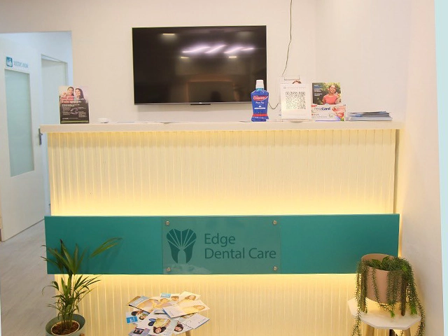 Modern dental reception with digital screens enhancing patient experience and comfort in Alwarpet