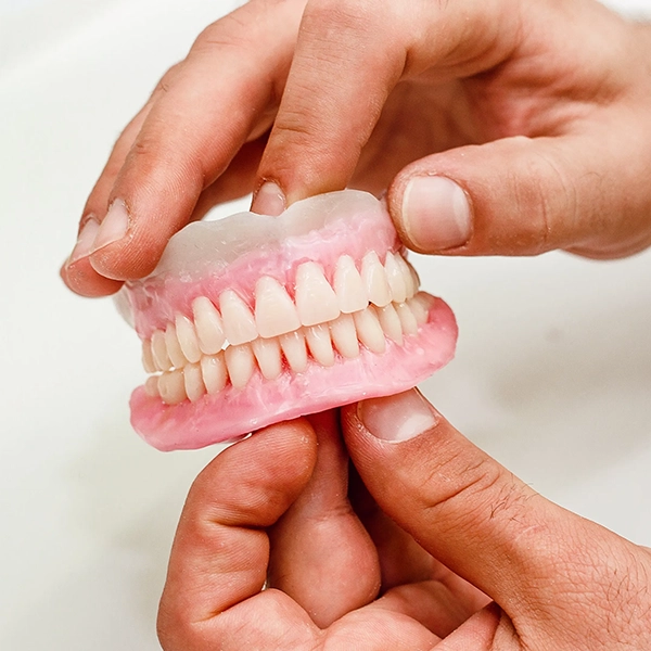 Dentists provide denture solutions to restore missing teeth, smiles, & chewing function in Alwarpet